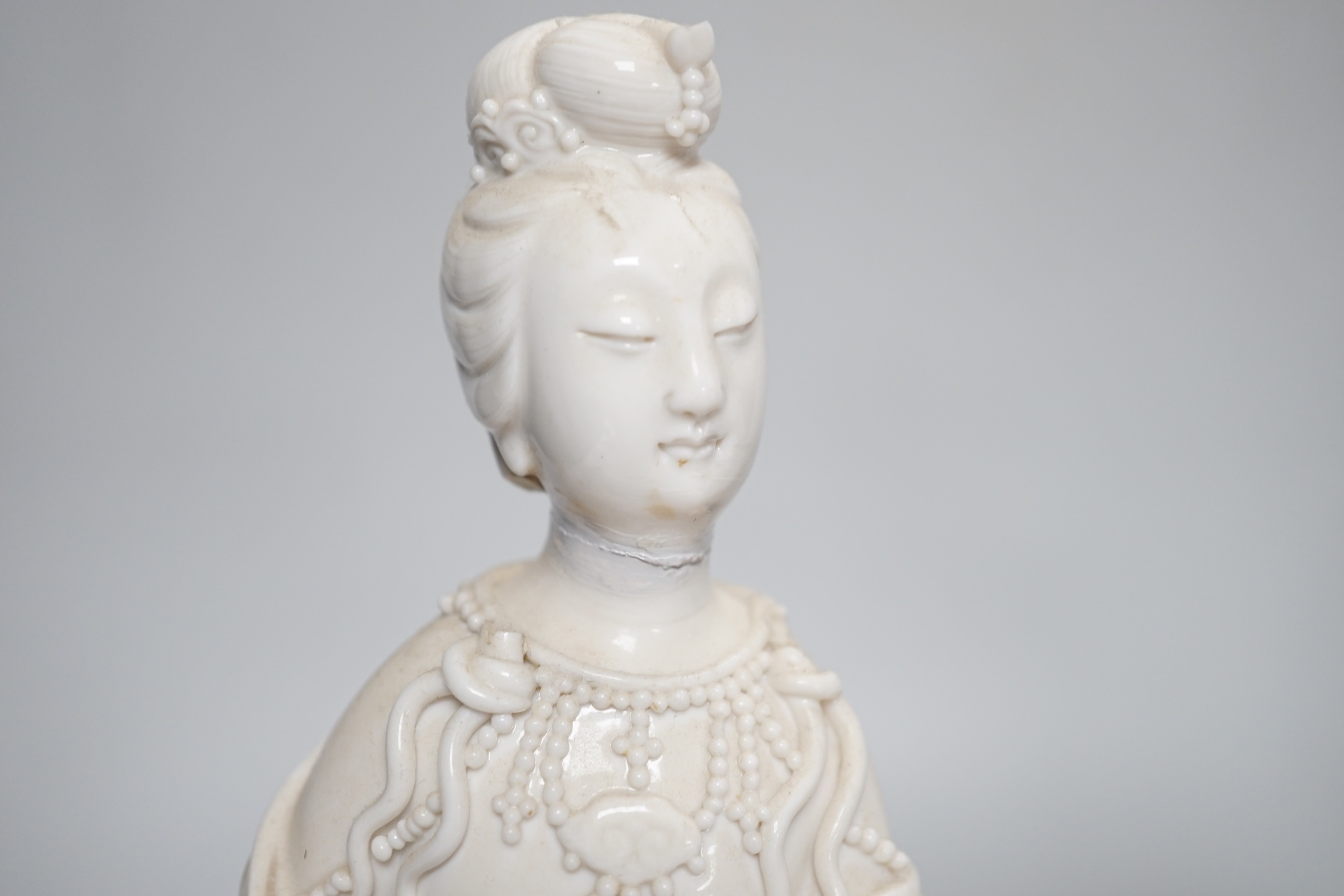 Three Chinese blanc de chine figures of Guanyin, 25cm